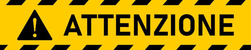 Banner giallo e nero con scritta “Attenzione” e simbolo di pericolo, stile segnaletica